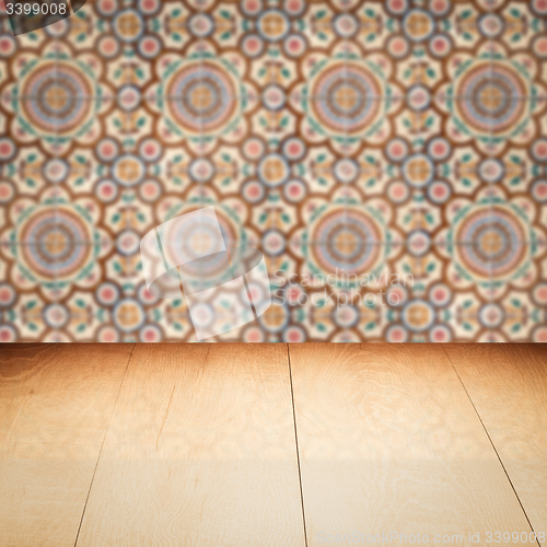 Image of Wood table top and blur vintage ceramic tile pattern wall