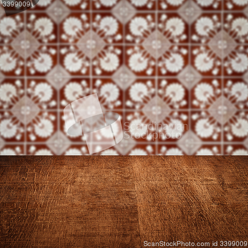 Image of Wood table top and blur vintage ceramic tile pattern wall