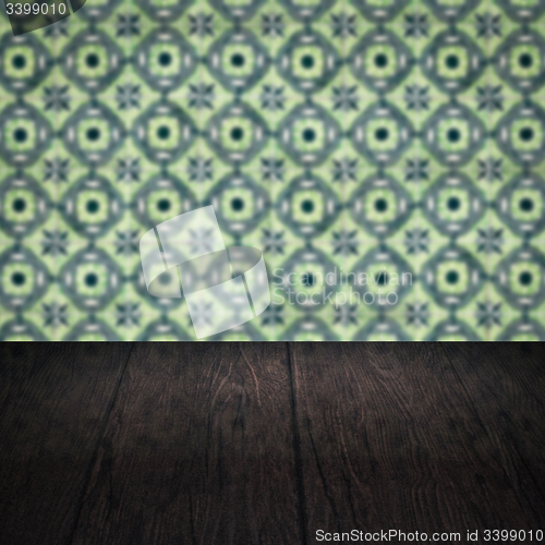 Image of Wood table top and blur vintage ceramic tile pattern wall