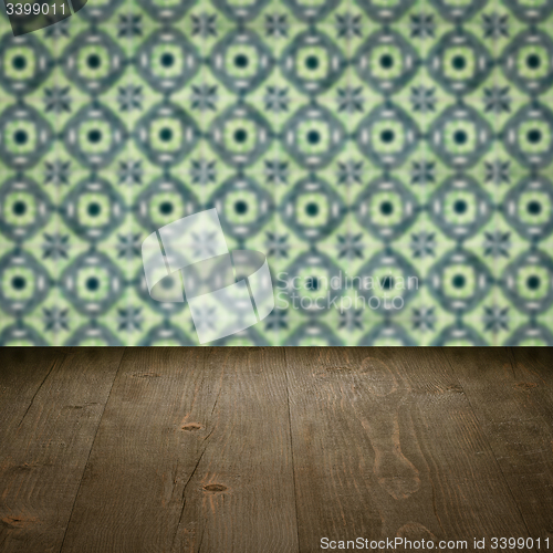 Image of Wood table top and blur vintage ceramic tile pattern wall