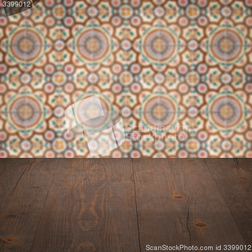 Image of Wood table top and blur vintage ceramic tile pattern wall