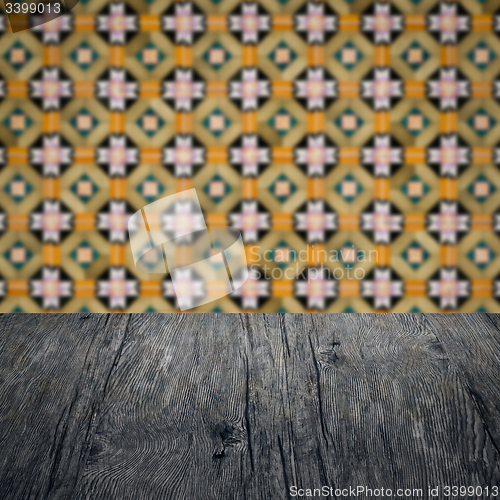 Image of Wood table top and blur vintage ceramic tile pattern wall