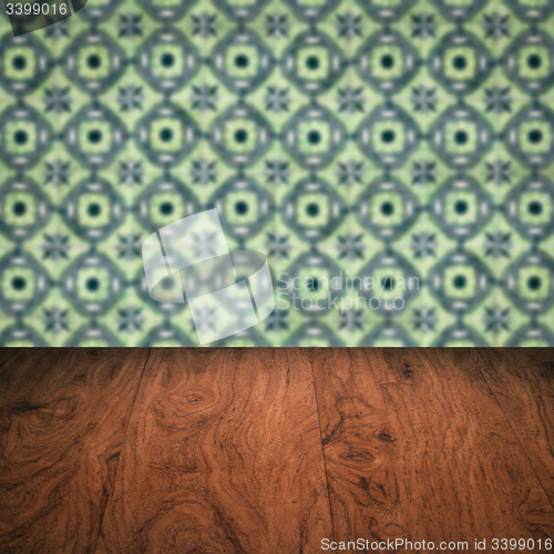 Image of Wood table top and blur vintage ceramic tile pattern wall