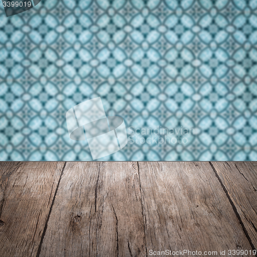 Image of Wood table top and blur vintage ceramic tile pattern wall