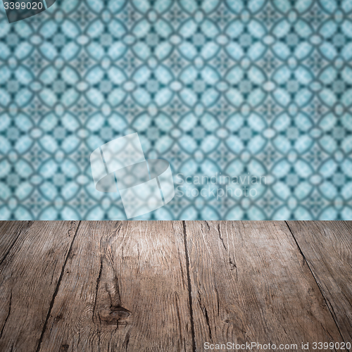 Image of Wood table top and blur vintage ceramic tile pattern wall