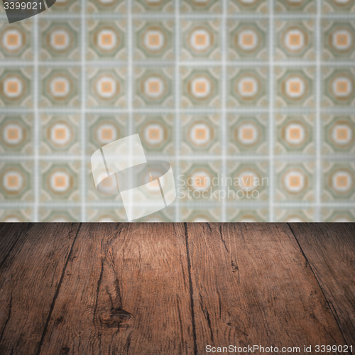 Image of Wood table top and blur vintage ceramic tile pattern wall