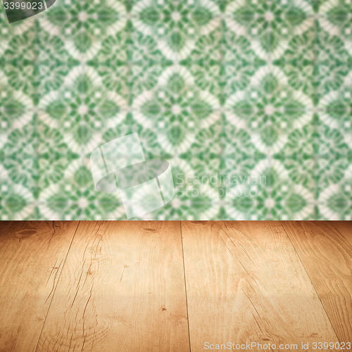 Image of Wood table top and blur vintage ceramic tile pattern wall