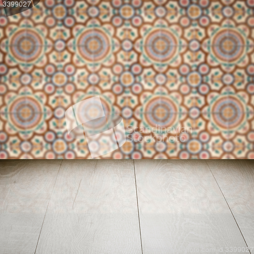 Image of Wood table top and blur vintage ceramic tile pattern wall