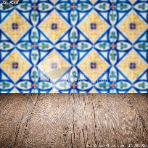 Image of Wood table top and blur vintage ceramic tile pattern wall