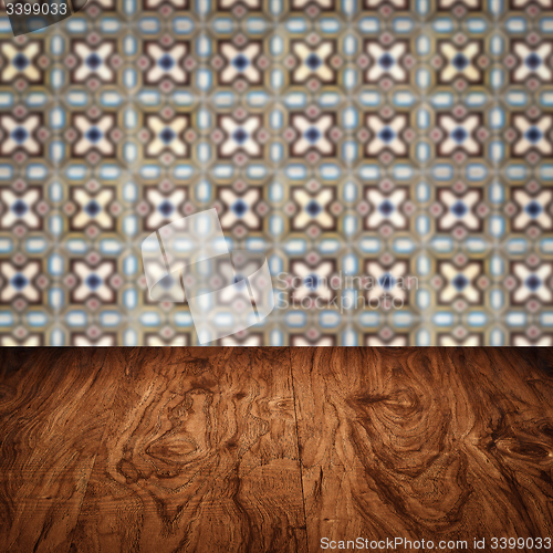 Image of Wood table top and blur vintage ceramic tile pattern wall