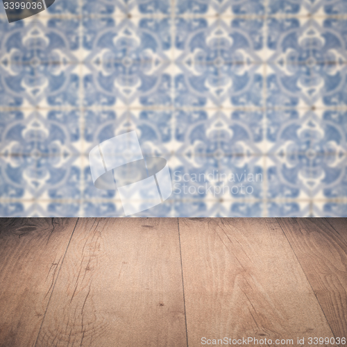 Image of Wood table top and blur vintage ceramic tile pattern wall