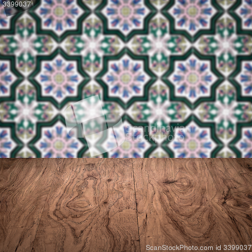 Image of Wood table top and blur vintage ceramic tile pattern wall