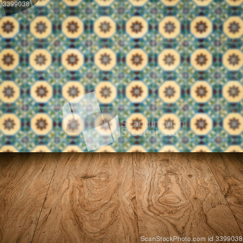 Image of Wood table top and blur vintage ceramic tile pattern wall