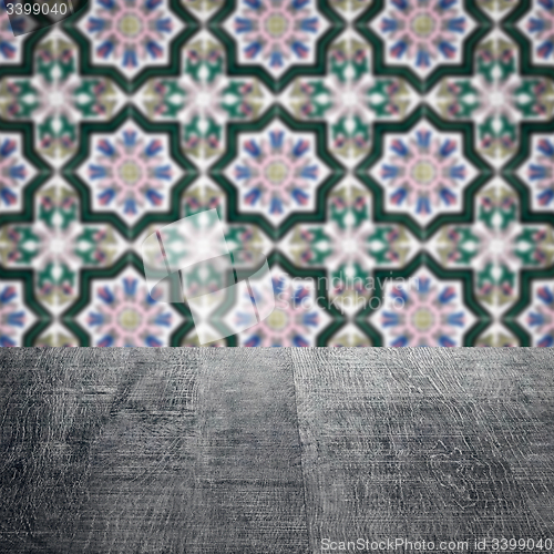 Image of Wood table top and blur vintage ceramic tile pattern wall