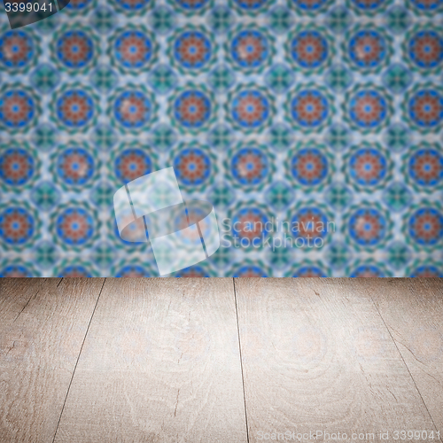 Image of Wood table top and blur vintage ceramic tile pattern wall