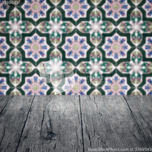 Image of Wood table top and blur vintage ceramic tile pattern wall