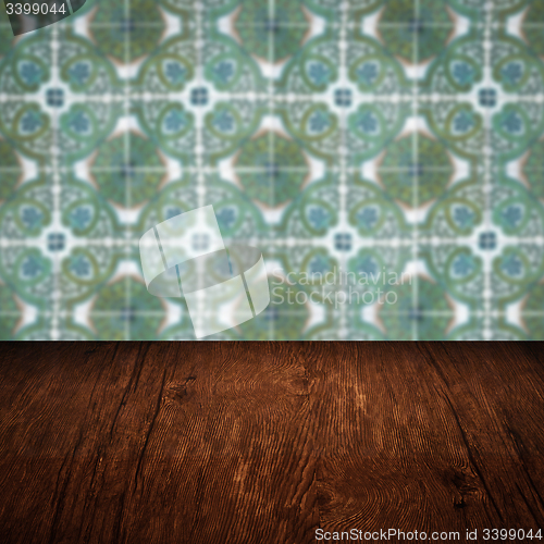 Image of Wood table top and blur vintage ceramic tile pattern wall