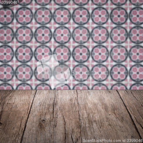 Image of Wood table top and blur vintage ceramic tile pattern wall