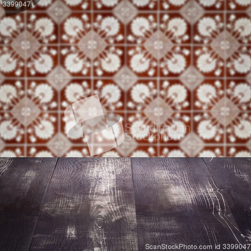 Image of Wood table top and blur vintage ceramic tile pattern wall