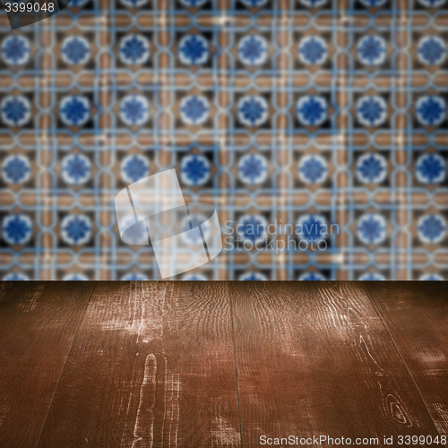 Image of Wood table top and blur vintage ceramic tile pattern wall