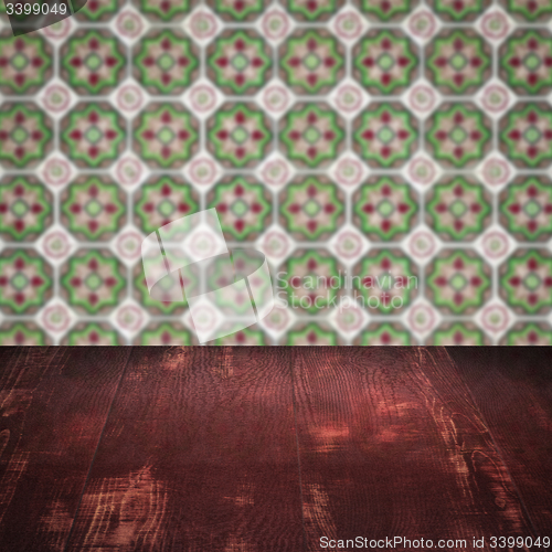 Image of Wood table top and blur vintage ceramic tile pattern wall