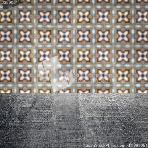 Image of Wood table top and blur vintage ceramic tile pattern wall