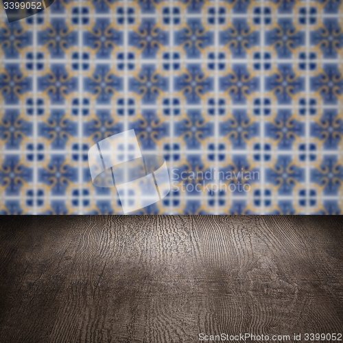 Image of Wood table top and blur vintage ceramic tile pattern wall