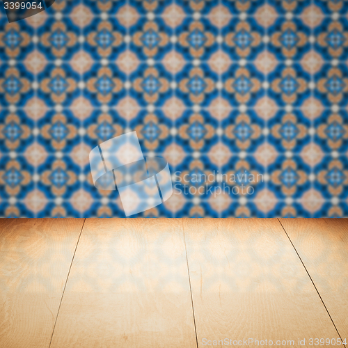 Image of Wood table top and blur vintage ceramic tile pattern wall