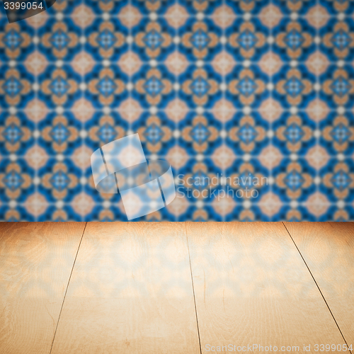 Image of Wood table top and blur vintage ceramic tile pattern wall