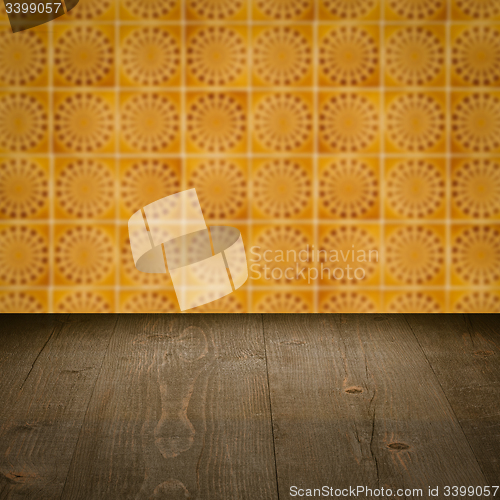 Image of Wood table top and blur vintage ceramic tile pattern wall