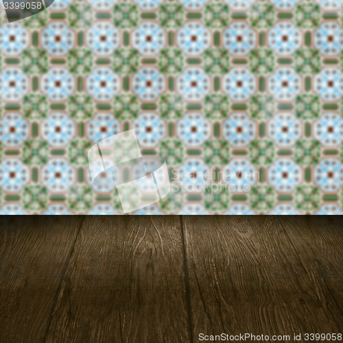 Image of Wood table top and blur vintage ceramic tile pattern wall