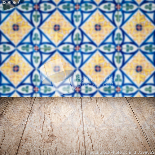 Image of Wood table top and blur vintage ceramic tile pattern wall