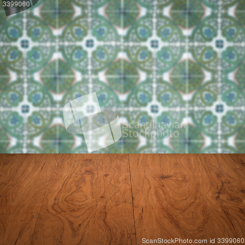 Image of Wood table top and blur vintage ceramic tile pattern wall