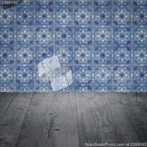 Image of Wood table top and blur vintage ceramic tile pattern wall