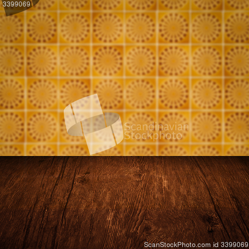 Image of Wood table top and blur vintage ceramic tile pattern wall