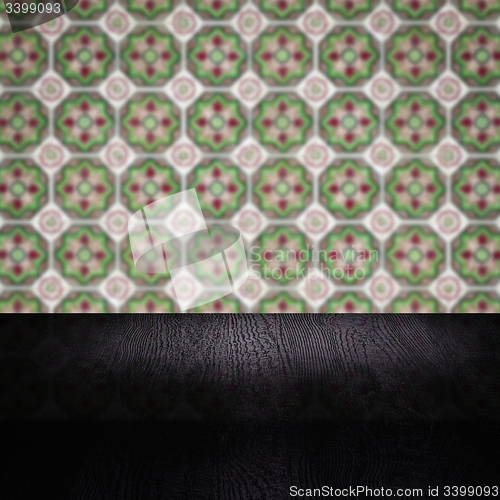 Image of Wood table top and blur vintage ceramic tile pattern wall