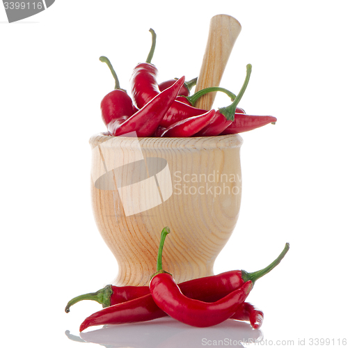 Image of Red chili in wooden mortar 