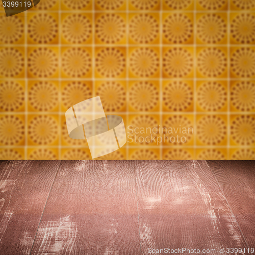 Image of Wood table top and blur vintage ceramic tile pattern wall