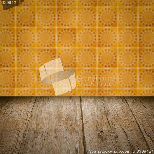 Image of Wood table top and blur vintage ceramic tile pattern wall