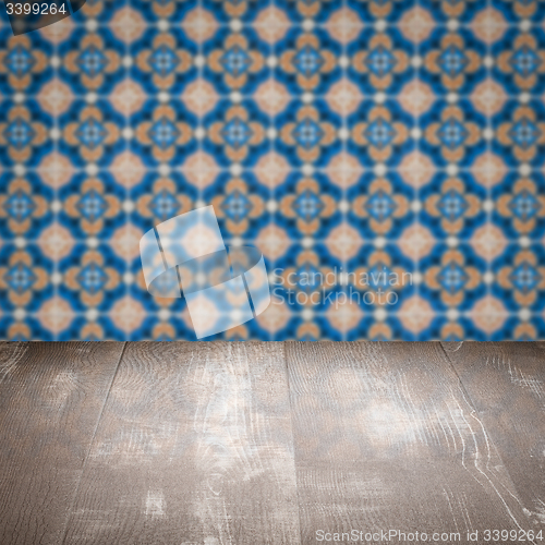 Image of Wood table top and blur vintage ceramic tile pattern wall