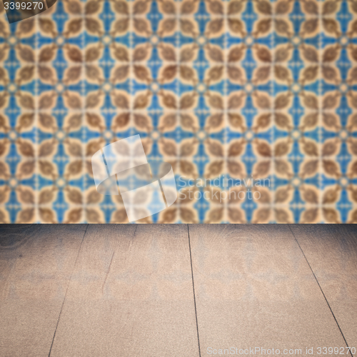 Image of Wood table top and blur vintage ceramic tile pattern wall