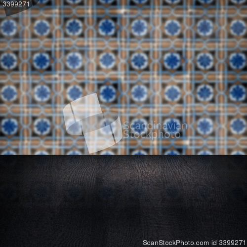 Image of Wood table top and blur vintage ceramic tile pattern wall