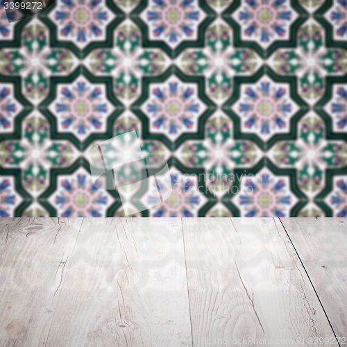 Image of Wood table top and blur vintage ceramic tile pattern wall