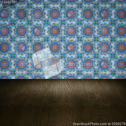 Image of Wood table top and blur vintage ceramic tile pattern wall