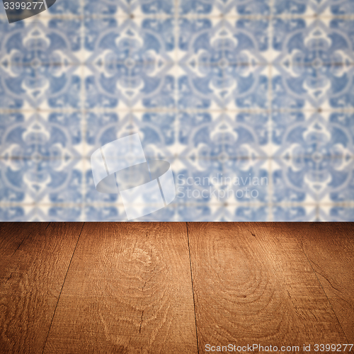 Image of Wood table top and blur vintage ceramic tile pattern wall