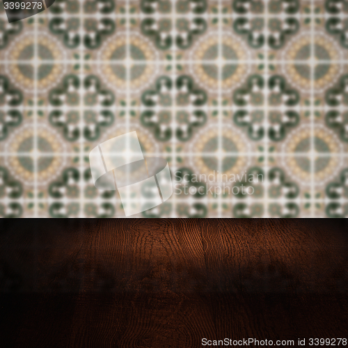 Image of Wood table top and blur vintage ceramic tile pattern wall