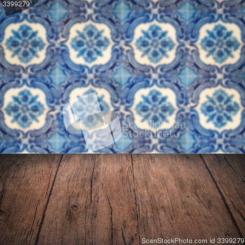 Image of Wood table top and blur vintage ceramic tile pattern wall