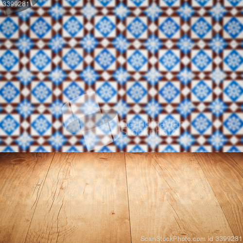 Image of Wood table top and blur vintage ceramic tile pattern wall