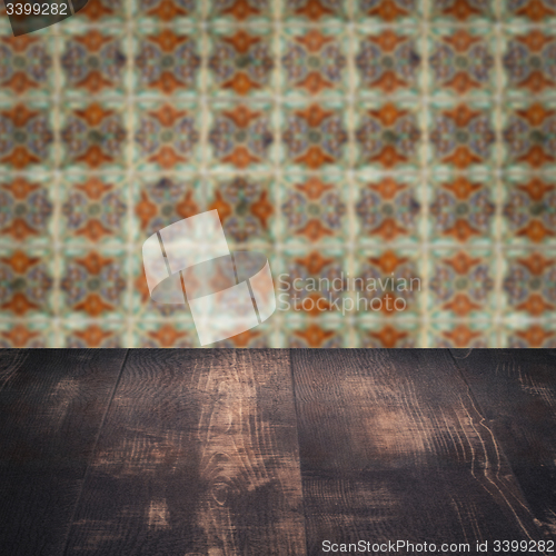 Image of Wood table top and blur vintage ceramic tile pattern wall