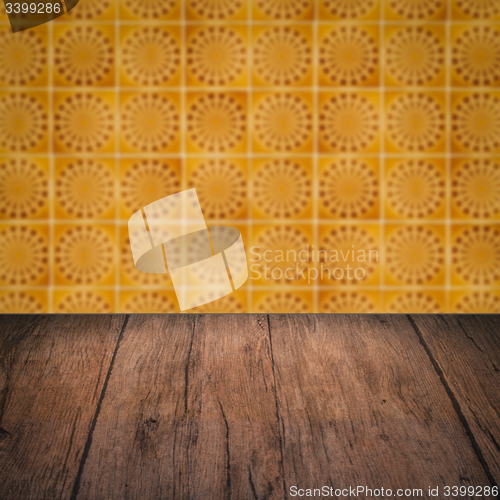 Image of Wood table top and blur vintage ceramic tile pattern wall